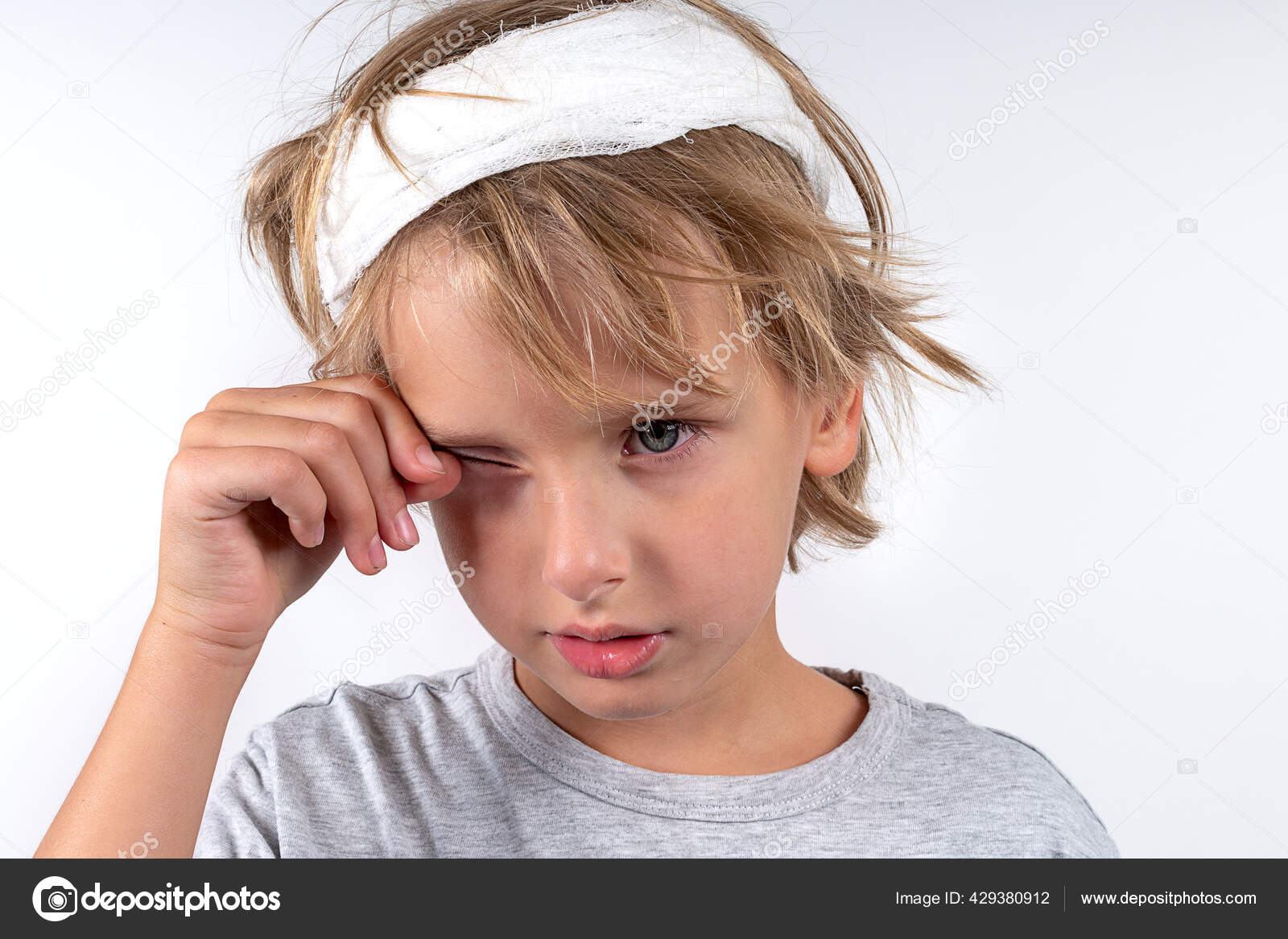 Portrait young caucasian cute boy blond hair with trauma injury and bandage head. Isolated on white background. Boy rubs his eyes from allergies Stock Photo by © 429380912 Portrait young caucasian cute boy blond hair with trauma injury and bandage head. Isolated on white background. Boy rubs his eyes from allergies Stock Photo by © 429380912