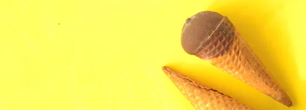 Choklad glass kon på solig sommar gul bakgrund. — Stockfoto