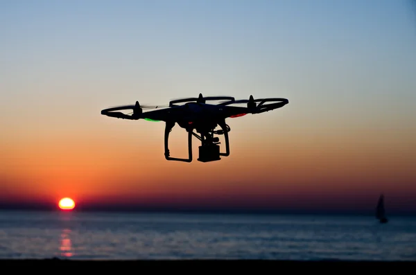 Drone volador con cámara en el cielo al atardecer — Foto de Stock