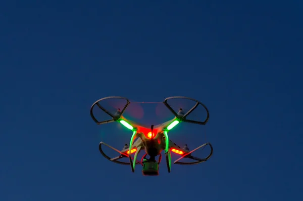 Flying drone with camera on the sky at sunset — Stock Photo, Image