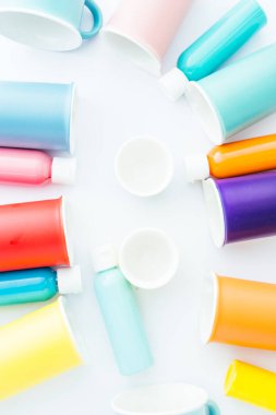 Renkli kase ve kavanoz, beyaz arka planda renklendirilmiş nesneler, üstünde pembe yumurta olan yumurta taşıyıcı, üst görünüm, düz kaplama, duvar kağıdı tarzı reklam tarzı..