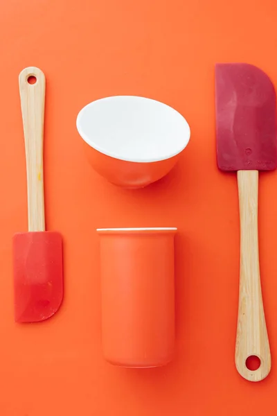 Orange Colored Bowl Red Spatula Colored Items Diplayed Red Background Stock Image