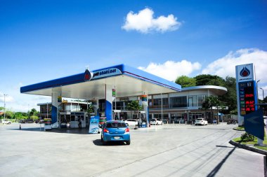 Ratchaburi, Tayland: 29 Mayıs 2021 - PTT benzin istasyonunun dış cephesi ticari binalar ve mavi gökyüzü