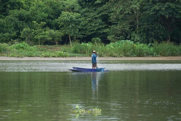 Lonely Man Stands Boat Collects Fish Net Forest Background — Stock Photo, Image