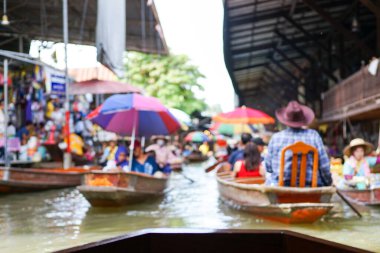 Defocused picture crowded of paddle boats with tourists in the floating market at Damnon Saduak, Thailand. Picture was blurred in purpose