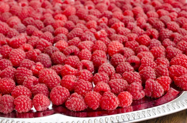 Raspberries are on a metal tray — Stock Photo, Image