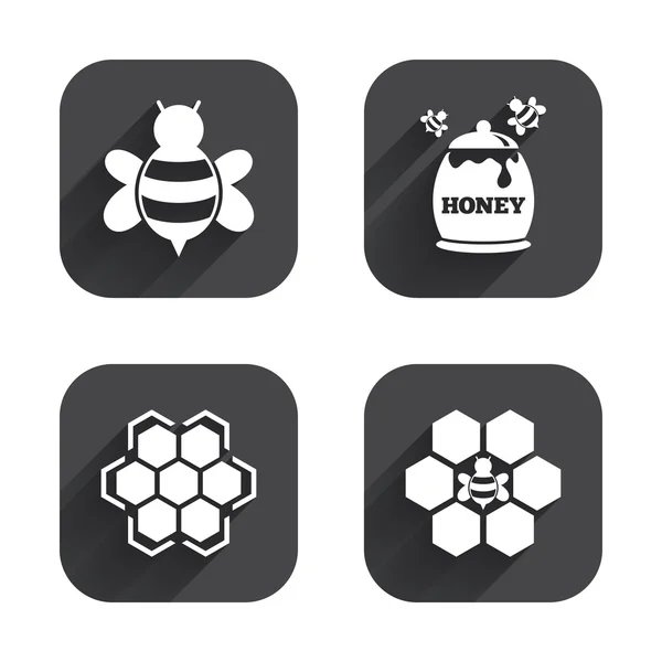 Celdas de panal con símbolos de abejas — Vector de stock