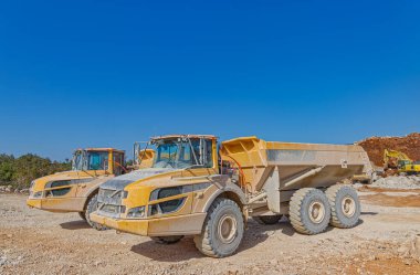 Yol inşaatında büyük kamyonlar.