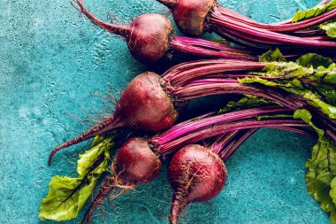 Mavi yüzeyde taze pişmemiş pancarların yakın plan görüntüsü