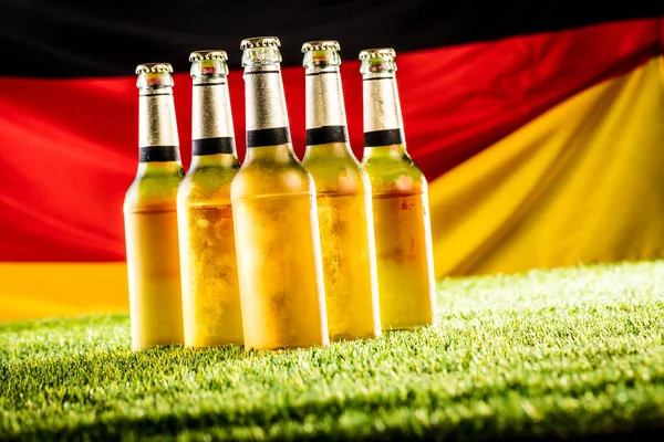 Nahaufnahme Von Bierflaschen Auf Grünem Rasen Deutsche Nationalflagge — Stockfoto