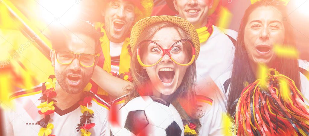 Group of enthusiastic German sport soccer fans celebrating victory.