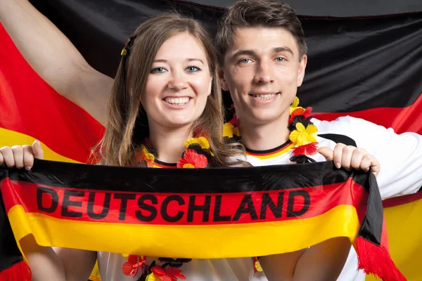 couple of enthusiastic German sport soccer fans celebrating victory. German Young Couple Supporting the Team