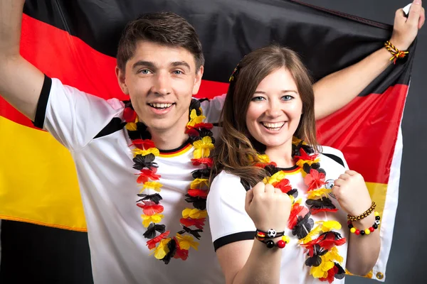 couple of enthusiastic German sport soccer fans celebrating victory. German Young Couple Supporting the Team