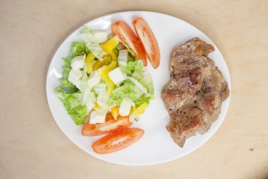 Domatesli kızarmış et ve sebze salatası.