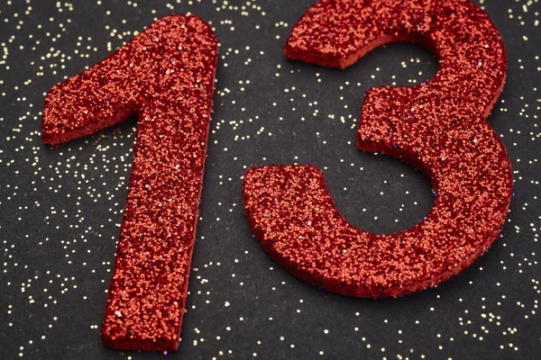 Number thirteen red color over a black background. Anniversary — Stock Photo, Image