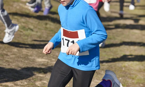 Junior athletic runner on a cross country race. Outdoor circuit — Stock Photo, Image