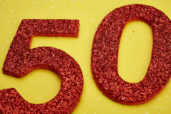 Number fifty red color over a yellow background. Anniversary — Stock Photo, Image