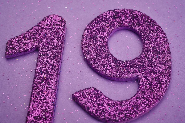 Number nineteen purple color over a purple background. Anniversa — Stock Photo, Image