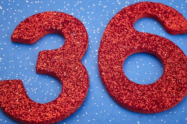 Number thirtysix red color over a blue background. Anniversary — Stock Photo, Image