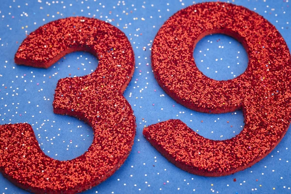 Number thirtynine red color over a blue background. Anniversary — Stock Photo, Image