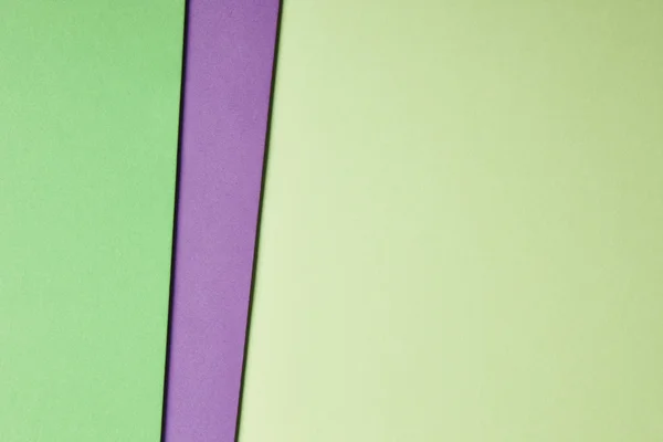 Colored cardboards background in green purple tone. Copy space