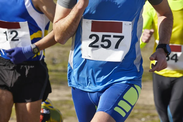 Male athletic runners on a cross country race. Outdoor circuit. — Stock Photo, Image