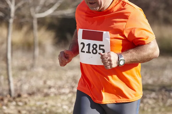 Senior athletic runner on a cross country race. Outdoor circuit — Stock Photo, Image