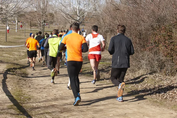 Men athletics runners on a countryside race. Outdoor circuit