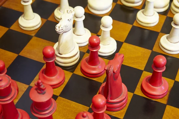 Chess pieces in red and white color over the table. — Stock Photo, Image