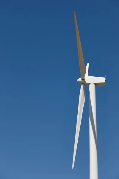 Wind turbines over blue sky. Clean alternative renewable energy Royalty Free Stock Images