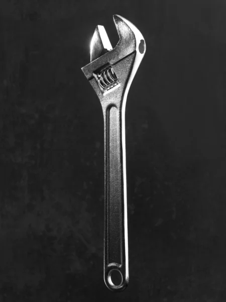 Wrench with black out of focus background — Stock Photo, Image
