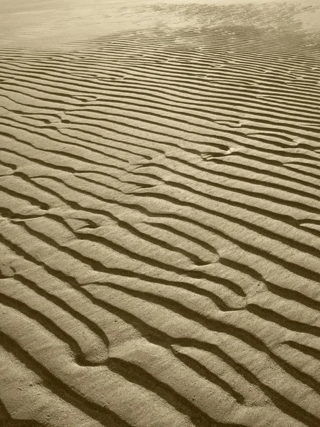 Sfondo spiaggia di sabbia in tono seppia — Foto Stock