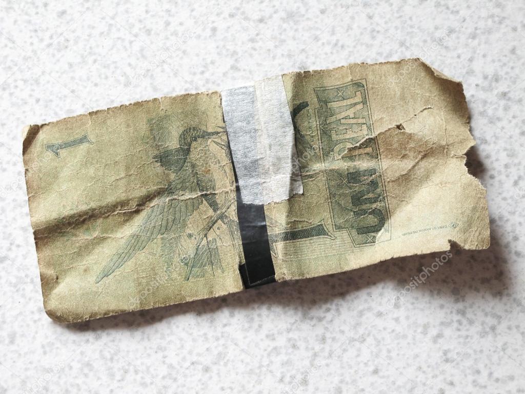 Broken brazilian banknote with background. Real.
