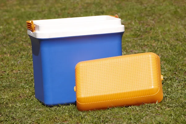 Picnic cooler in the grass in blue and orange tone — Stock Photo, Image