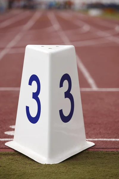 Number three signpost in a athletic running track — Stock Photo, Image