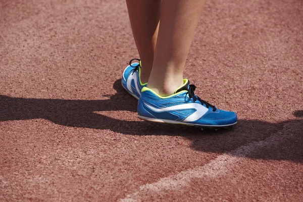 Jumping sport shoes in the athletic field ground — Stock Fotó