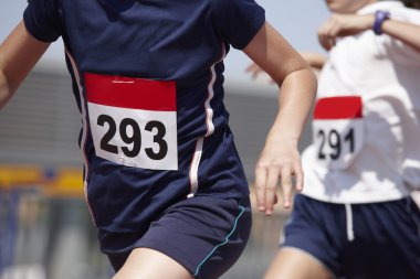 Male runners finalizing a race in a running track