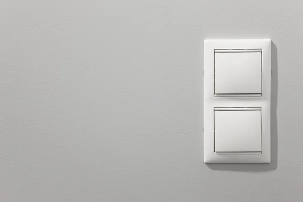 Luz blanca conmuta sobre una pared gris —  Fotos de Stock