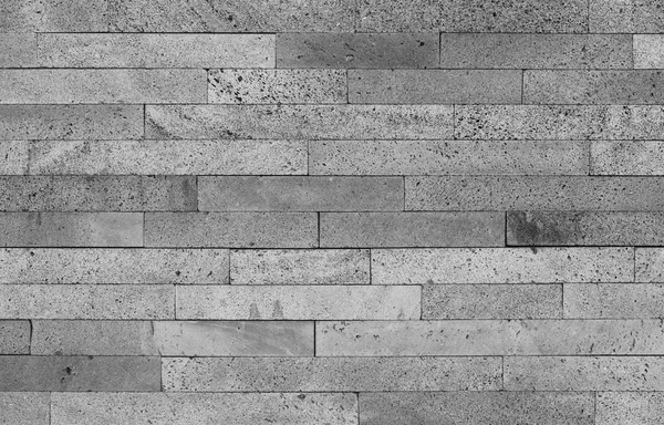 Vulkanisk sten tegel vägg bakgrund i svart och vitt — Stockfoto