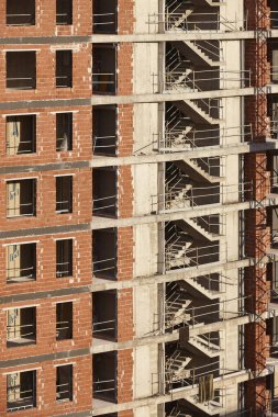 Building facade finished with bricks under construction. Construction industry