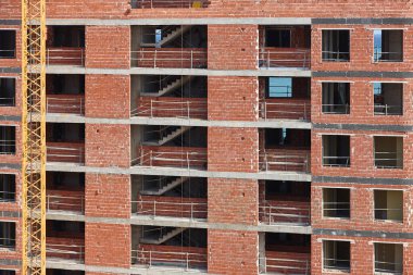 Building facade finished with bricks under construction. Construction industry
