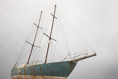 Rusty wooden sailboat waiting to be scraping in Azores. Portugal clipart