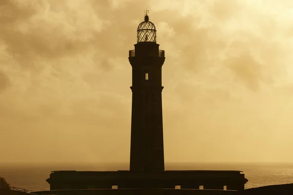 Lighthouse at sunset in Faial island. Ponta dos Capelinhos. Azor — Stock Photo, Image