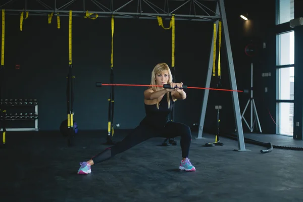 Woman in a gym exercising Stock Picture