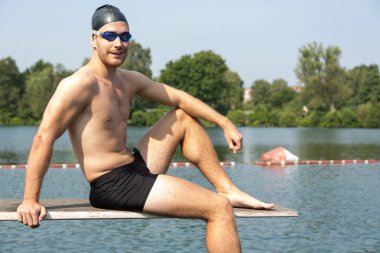 Tramplen güneşin Gölü üzerinde oturan adam