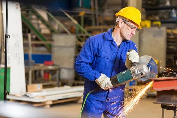 Steel construction worker cutting metal with angle grinder — Stock Photo, Image