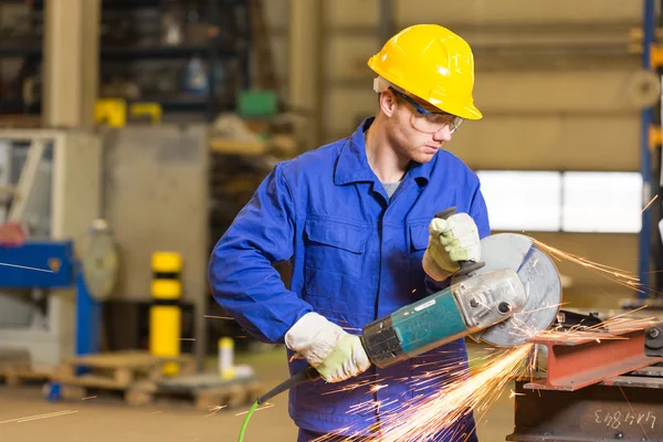 Steel construction worker cutting metal with angle grinder — Stock Photo, Image