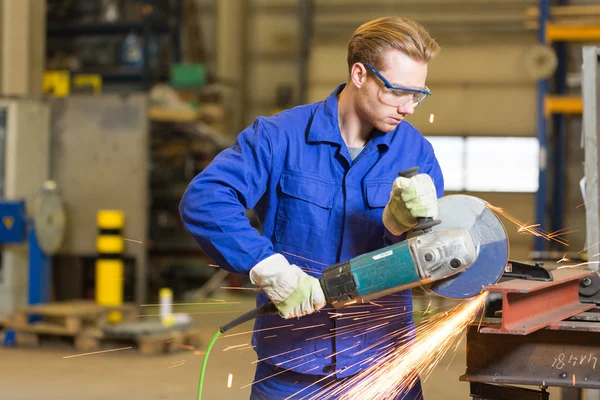 Steel construction worker cutting metal with angle grinder — Stock Photo, Image