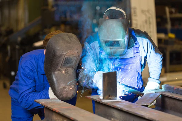 Two steel construction workers welding metal — Stock Photo, Image