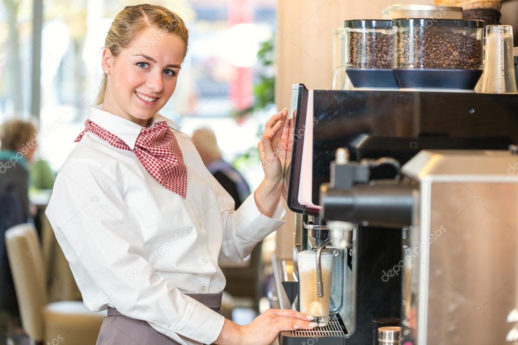 Waitress working at coffee machine in bakery or cafe